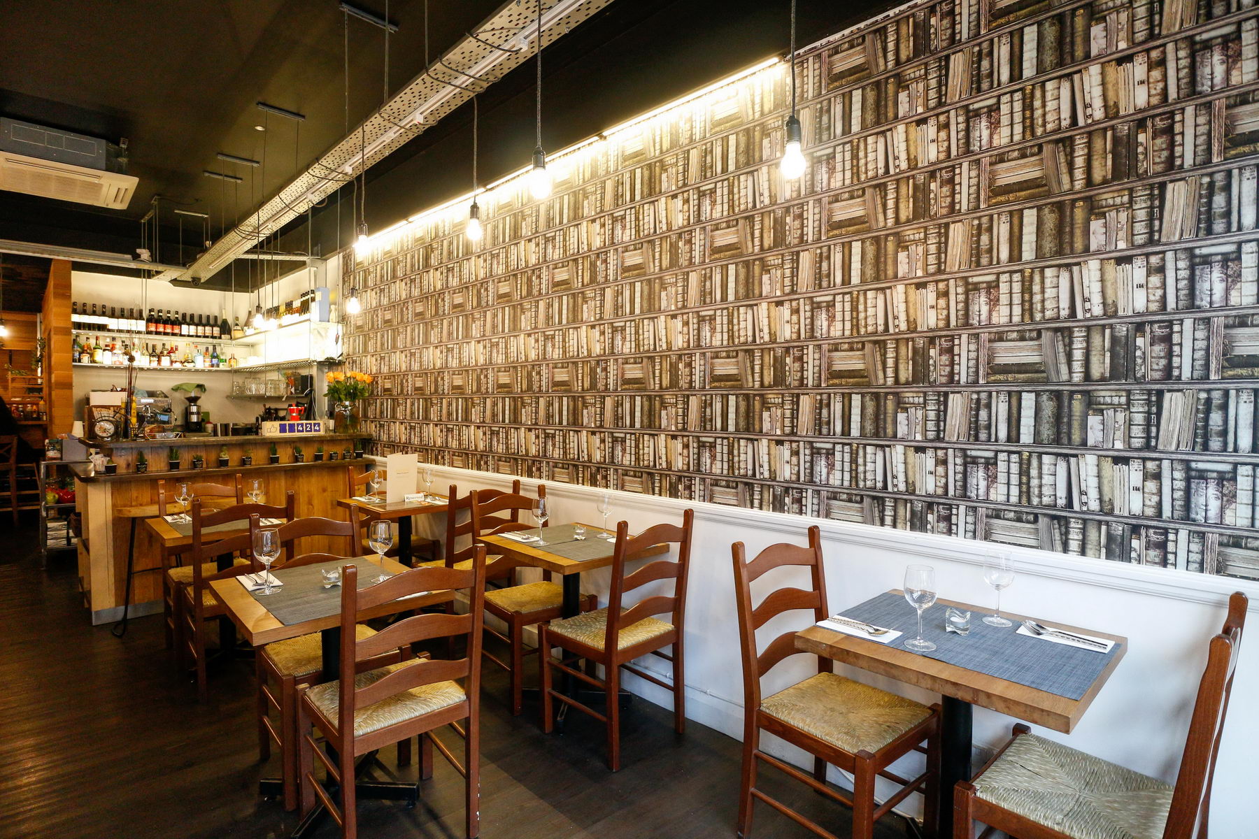 The warm wood and book-lined dining room at Paccata